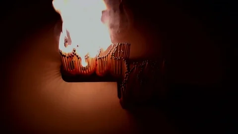 Pack of Man lights a match in darkness. Slow Motion Stock Footage 73563404
