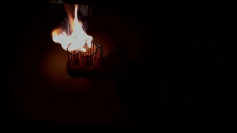 Pack of Man lights a match in darkness. Slow Motion Stock Footage 73578499