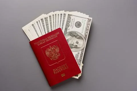A pack of one hundred US dollars in the passport Stock Photos