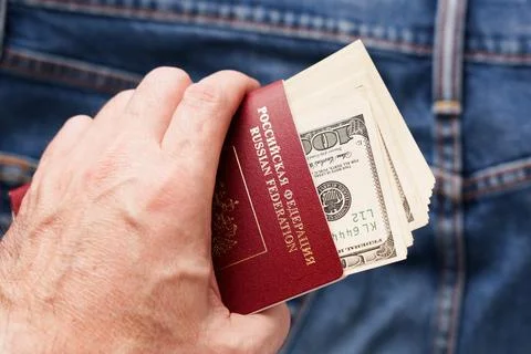 A pack of one hundred US dollars in the passport Stock Photos