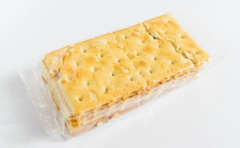 A pack or portion of savory crackers with packet in transparent plastic sachet Stockfoto's