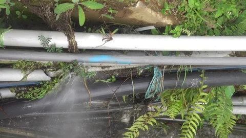 A pack of plastic water pipes, some of which are leaking Stock Footage 317003731