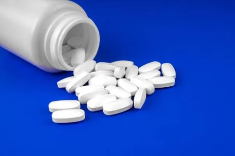 Pack of scattered tablets on a blue background Stock Photos