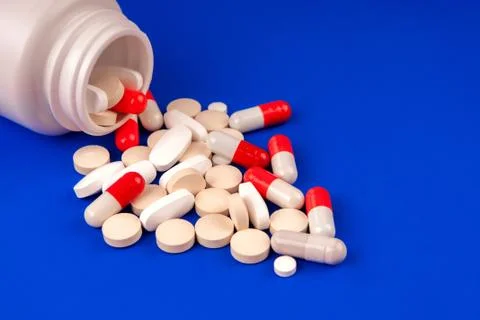 Pack of scattered tablets on a blue background Stock Photos