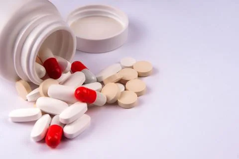 Pack of scattered tablets on a light background Stock Photos