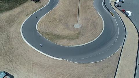Pack of speed bikes come around a hairpin turn Stock Footage 126739785
