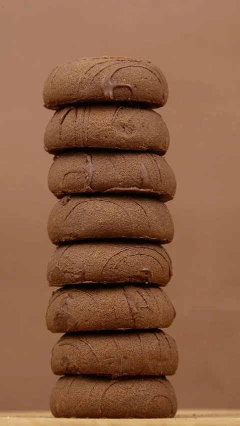 A pack, stack of chocolate gingerbread cookies or cookies rotate on a brown Stock Footage 275572461