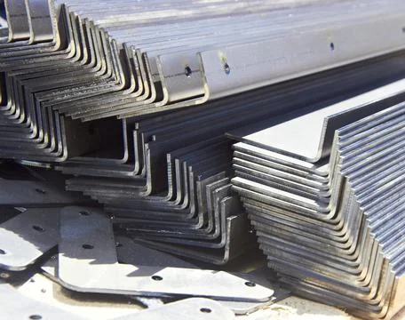 Pack of steel sheets bent into angles in a workshop Stock Photos