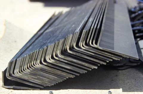 Pack of steel sheets bent into angles in a workshop Stock Photos