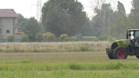 Pack of three tractor and farmer working in a field Stock-Footage 112751831