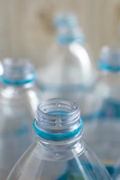 Pack of transparent empty pet plastic water botles with blue label, no cap an Stock Photos
