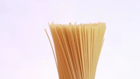 A pack of uncooked spaghetti rotates around Stock Footage 236101940