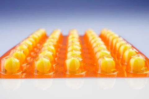 Pack of yellow tablets Stock Photos