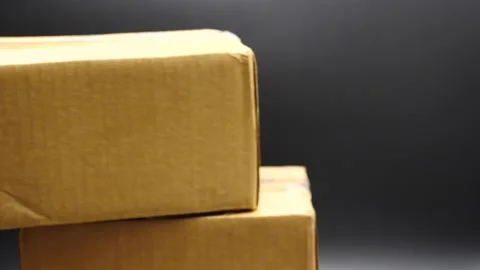 Package being delivered in slow motion isolated on black Stock Footage 169777733
