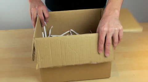 Package being packed up into cardboard box for delivery Vídeos de archivo 34528904