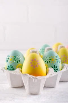 Package box with painted easter eggs. Easter holiday background. Copy space Stock Photos