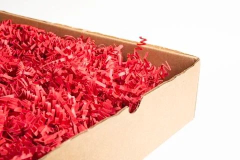 Package Box With Red Paper Strips Filling Stock-Fotos
