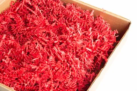 Package Box With Red Paper Strips Filling Stock Photos