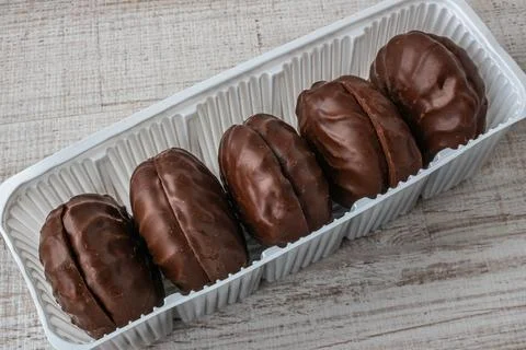 A package of chocolate marshmallows close-up lying on a wooden table. The Stock Photos