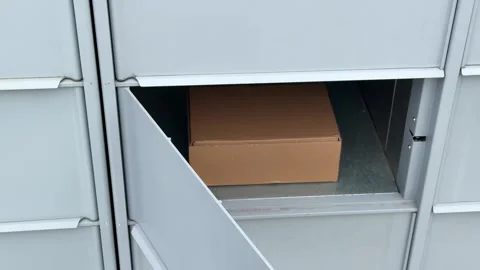 Package delivery in residential parcel locker box Stock Footage 330125938