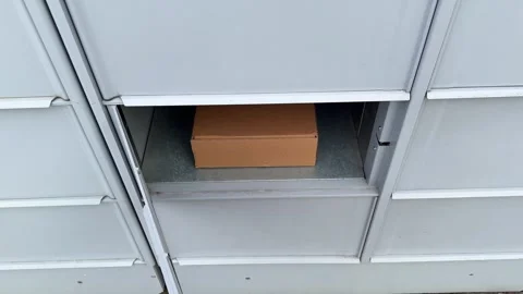 Package delivery in residential parcel locker box Stock Footage 330125951