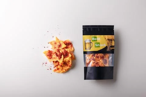 Package of dry pumpkin slices, vegetable chips, crisps with pepper and paprika Stock Photos