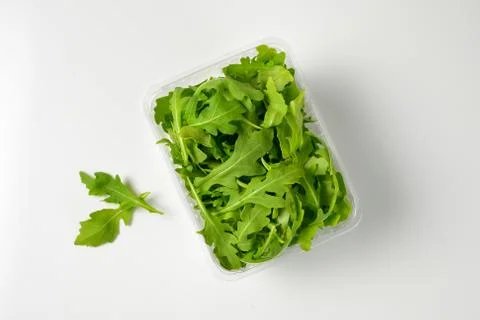 Package of fresh arugula leaves Stock Photos