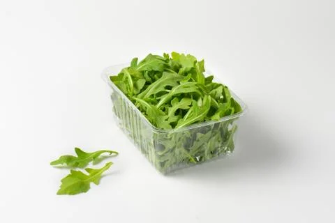 Package of fresh arugula leaves Stock Photos