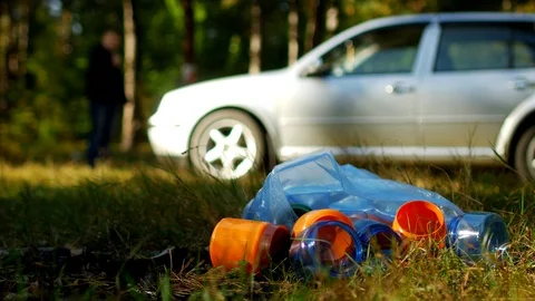 A package of garbage with plastic bottles is lying on the nature, in the Stock Footage 96426243