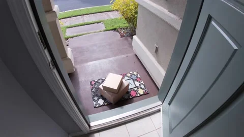 Package on mat outside door which opens and man picks up Stock Footage 120812439