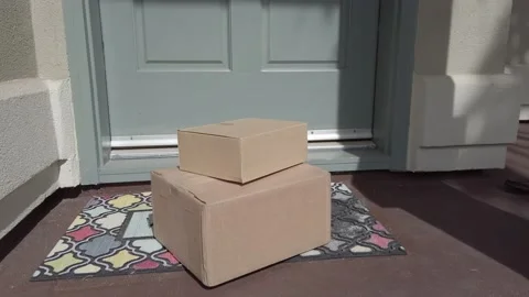 Package on mat outside door which opens and man picks up Stock Footage 120812450