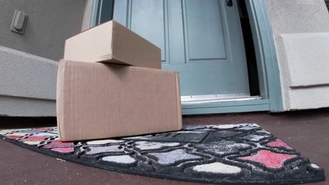 Package on mat outside door which opens and man picks up Stock Footage 120812811