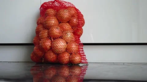 Package with onions is on the floor Stock Footage 142201254