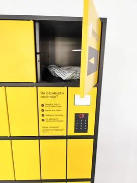 Package Parcel Inside Open Cell of Yellow Ukrposhta Automated Parcel Locker Stock Photos