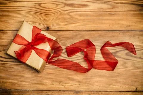 A package with a red ribbon Foto stock