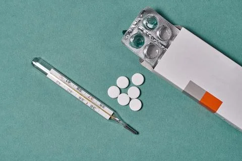 Package with tablets and thermometer Photos