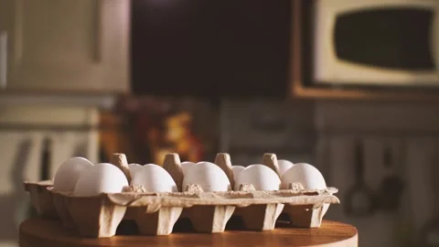 A package of ten white eggs against the backdrop of a kitchen interior Stock-Footage 160459363
