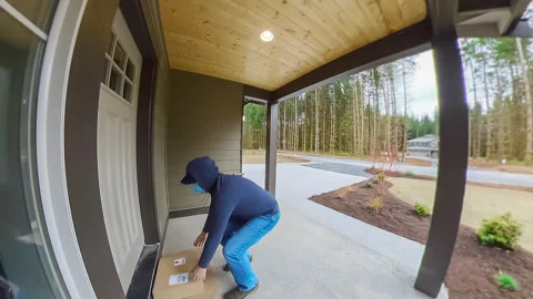 Package thief stealing package from door step Stock Footage 151226451