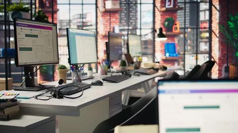 Package tracking software and spreadsheets displayed on PC screens in office Stock Photos