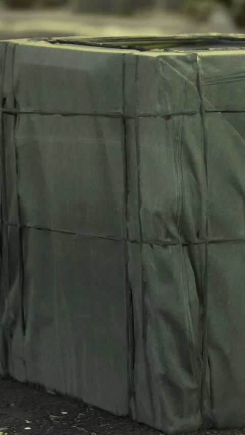 Package wrapped in green material at a delivery area in the afternoon Stock Footage 336582001