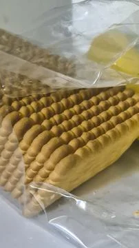 Packaged biscuits displayed in a transparent bag, showcasing their textured Stock Photos
