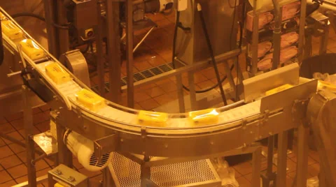 Packaged blocks of Cheddar cheese on a conveyor belt Stock-Footage 39173097
