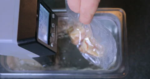 Packaged fresh meat is boiled in water in a professional kitchen. Stock Footage 228677753