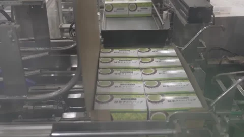 Packaged Green Tea Boxes Traveling Down the Line Stock Footage 340010060