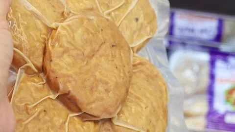 Packaged meat patties in vacuum sealed plastic wrapping Stock Footage 336663356