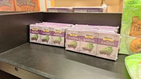 Packaged raisin boxes on a grocery store shelf. Stock Photos