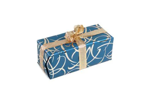 Packaged rectangular gift in blue packaging with gold bow and gold pattern on a Foto stock