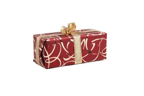 Packaged rectangular gift in burgundy packaging with gold bow and gold pattern Stock Photos