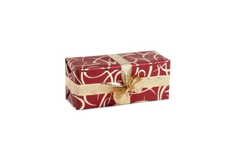 Packaged rectangular gift in burgundy packaging with gold bow and gold pattern Stock Photos