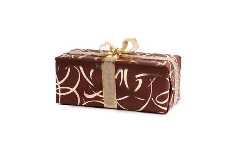 Packaged rectangular gift in dark brown packaging with gold bow and gold pattern Stock Photos